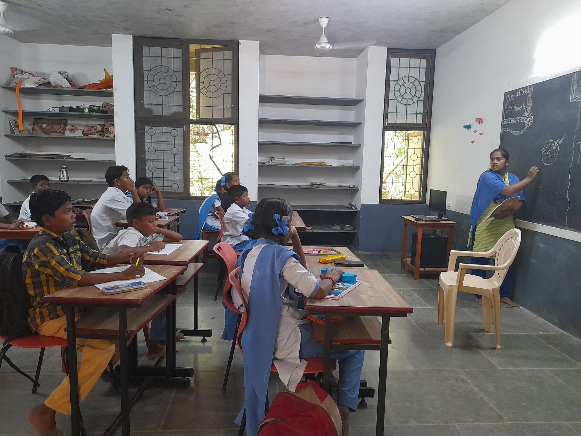 Bhuvana working as an English teacher at part of her volunteer work, at Isai Ambalam School